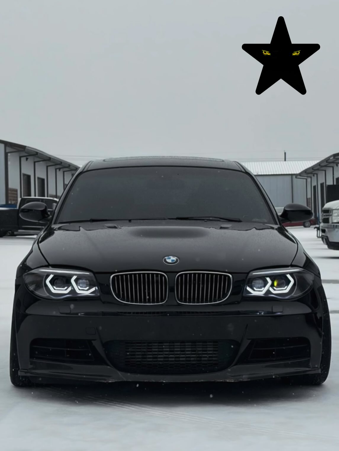 Front view of the black BMW 135i parked in snow